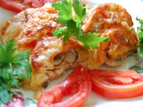 Fish baked with mushrooms and tomatoes